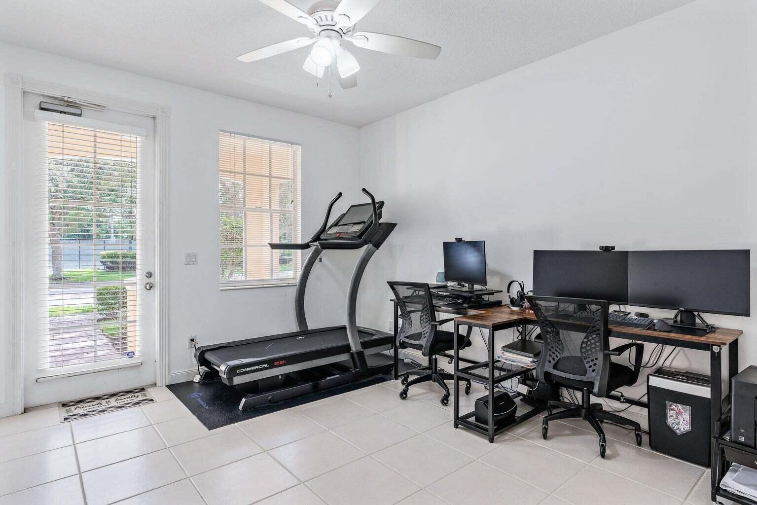 4030 Parkside Drive Jupiter, FL 33458 - Photo 11 of 26 a room with gym equipment and wooden floor