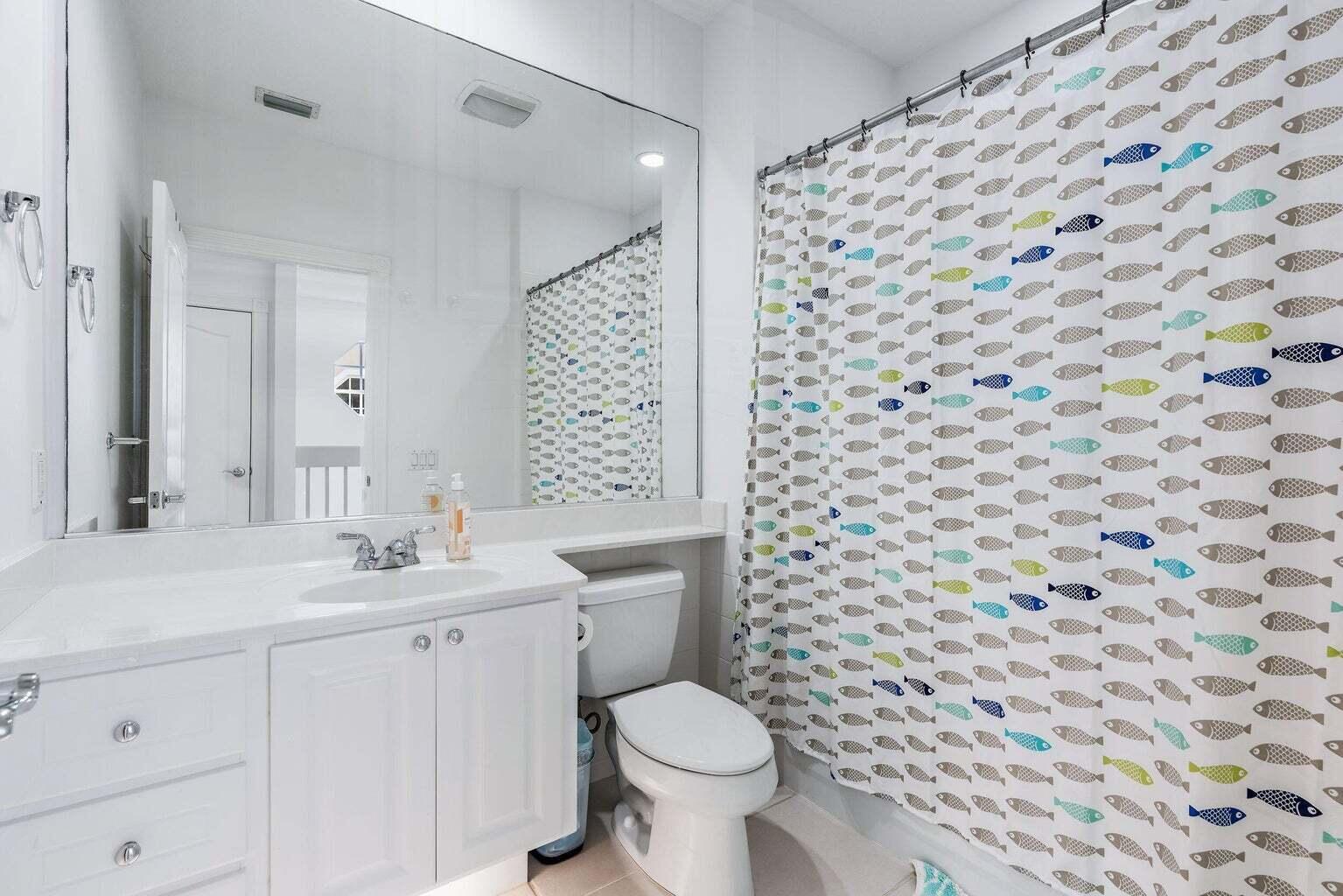 4030 Parkside Drive Jupiter, FL 33458 - Photo 18 of 26 a bathroom with a sink toilet and a mirror