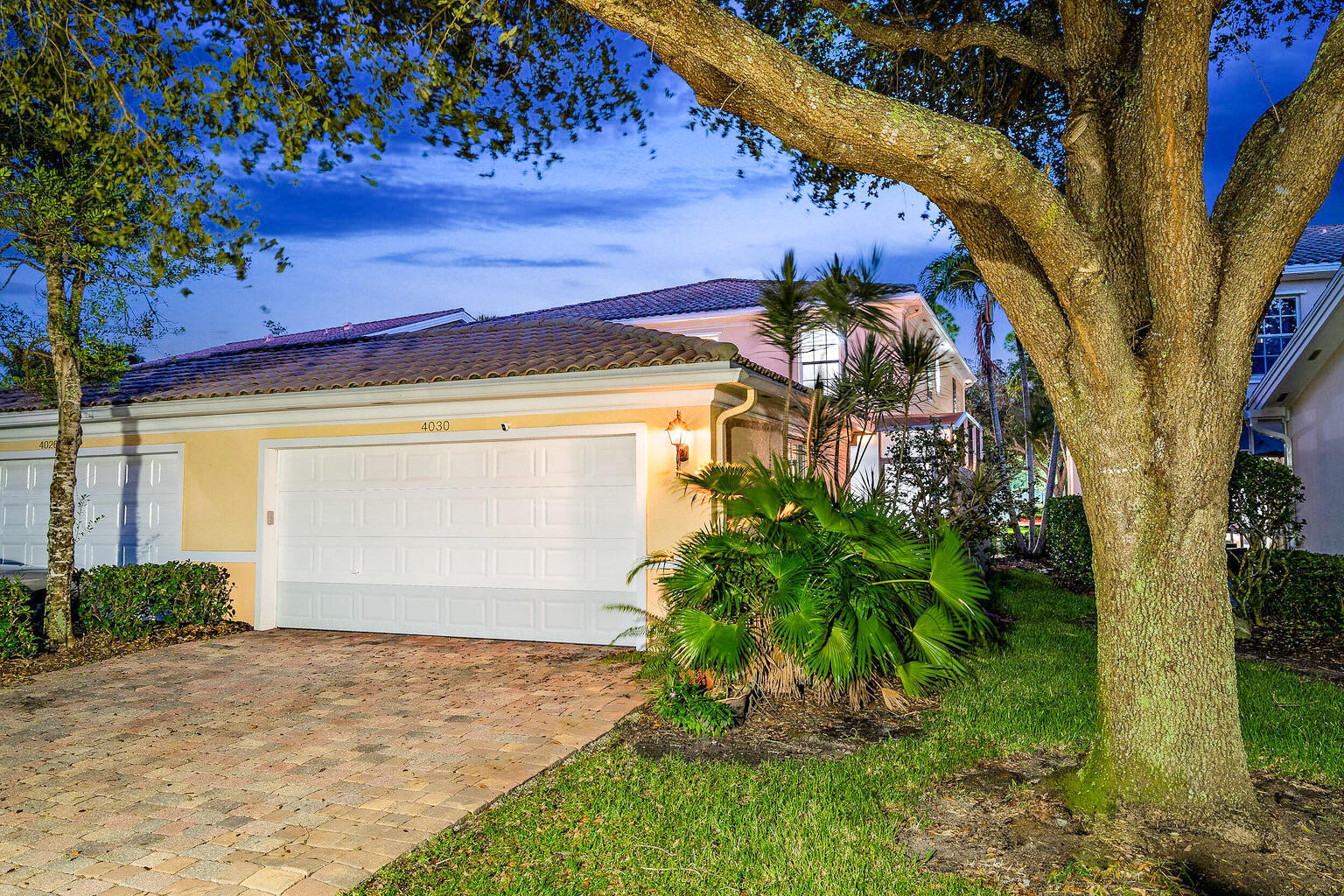4030 Parkside Drive Jupiter, FL 33458 - Photo 5 of 26 a front view of a house with a yard and garage