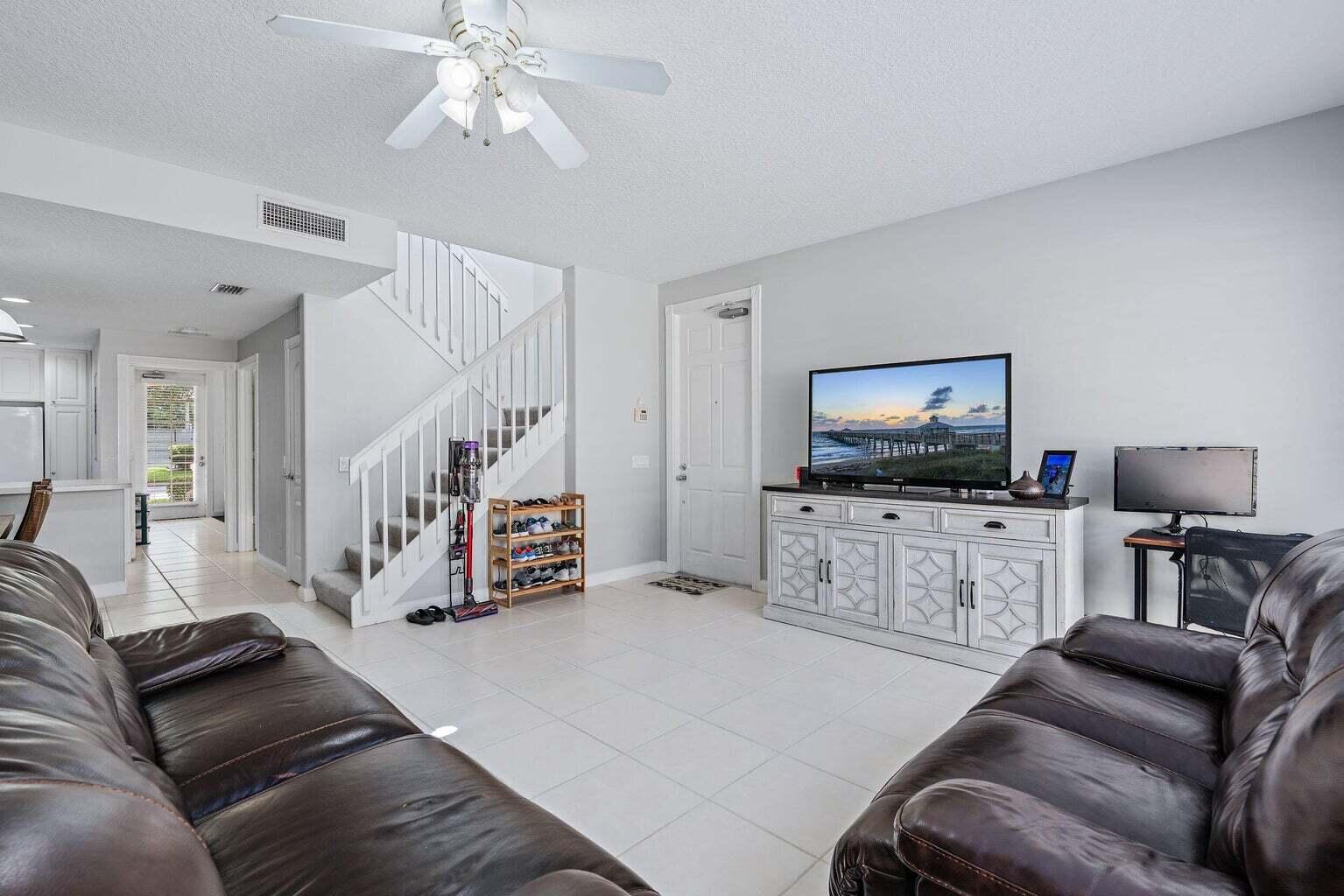 4030 Parkside Drive Jupiter, FL 33458 - Photo 8 of 26 a living room with furniture and a flat screen tv