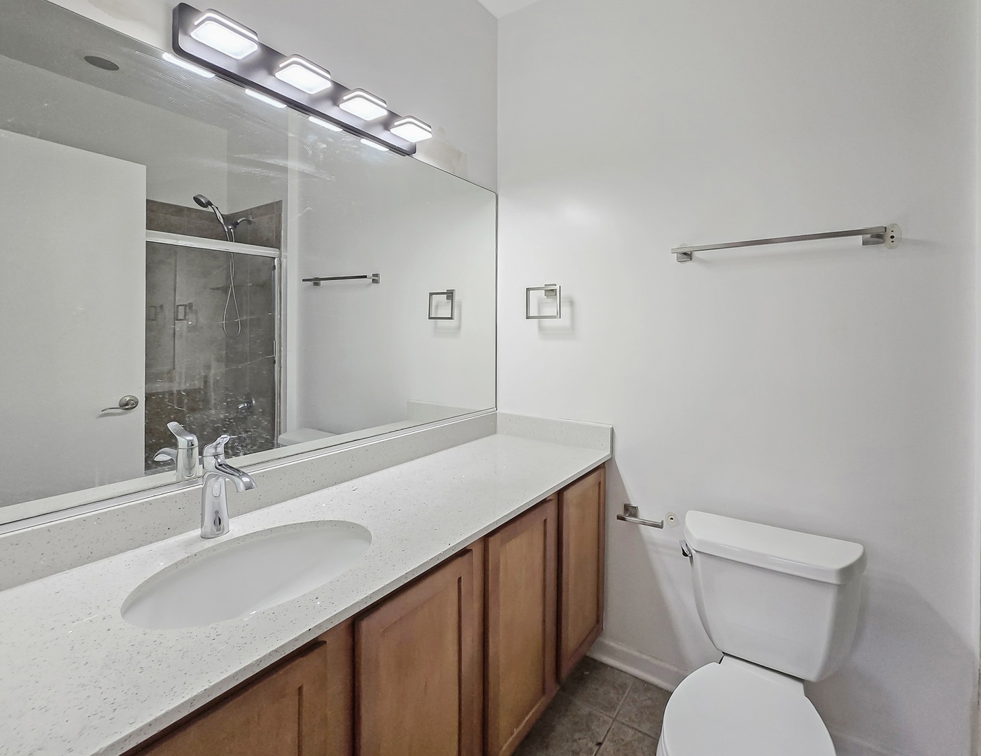 2415 West 32nd Place Chicago, IL 60608 - Photo 15 of 25 a bathroom with a sink a toilet a mirror and shower