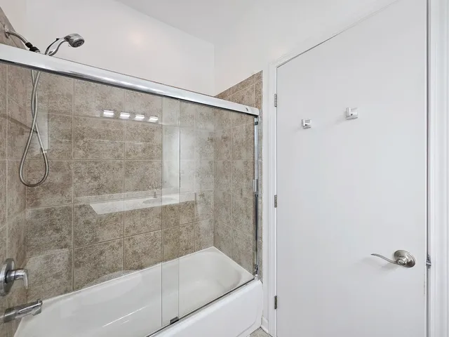 a bathroom with a shower and a bath tub