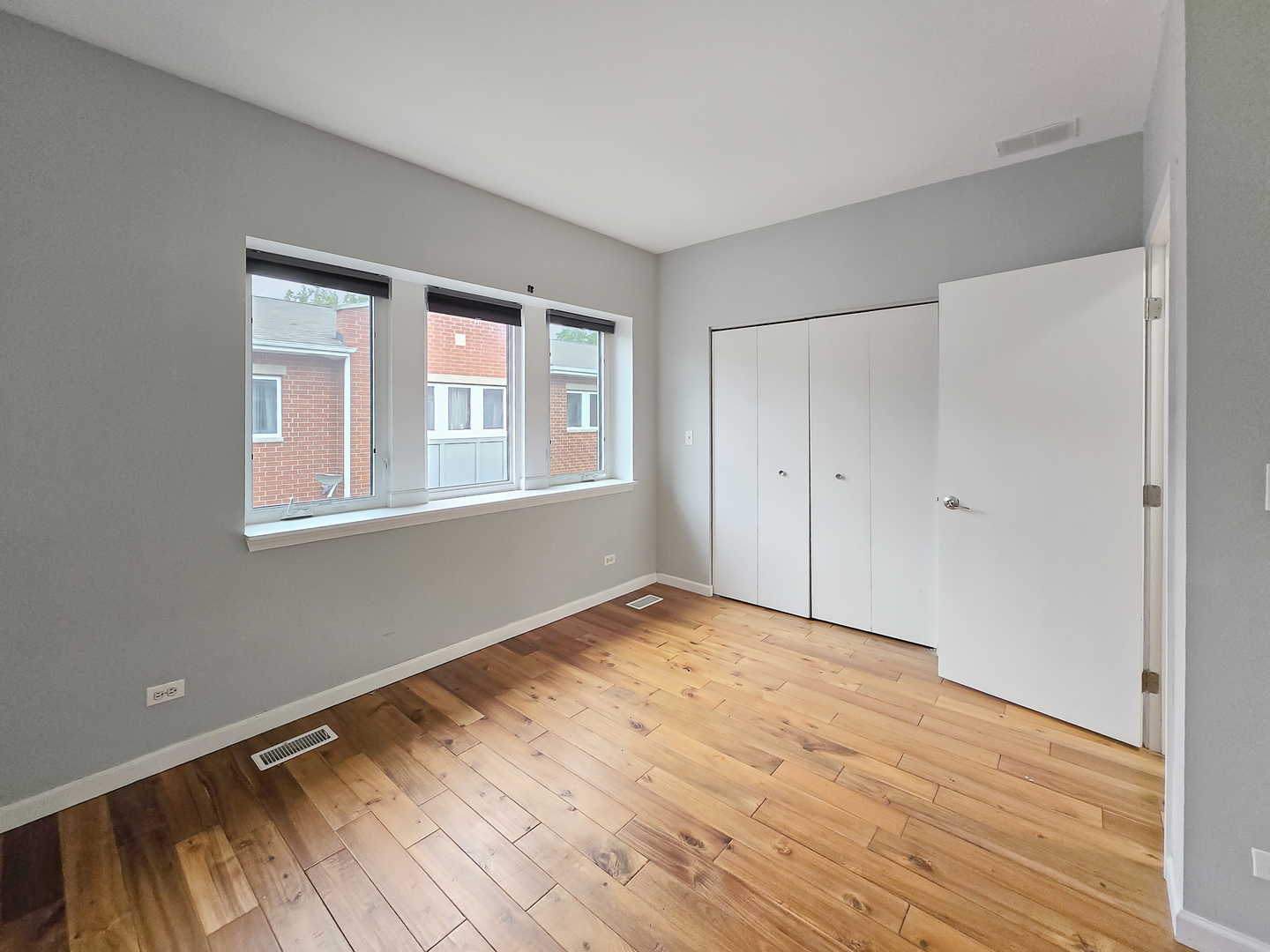 2415 West 32nd Place Chicago, IL 60608 - Photo 17 of 25 a view of an empty room with wooden floor and a window