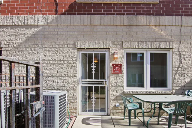 a front view of a building with a table and chairs