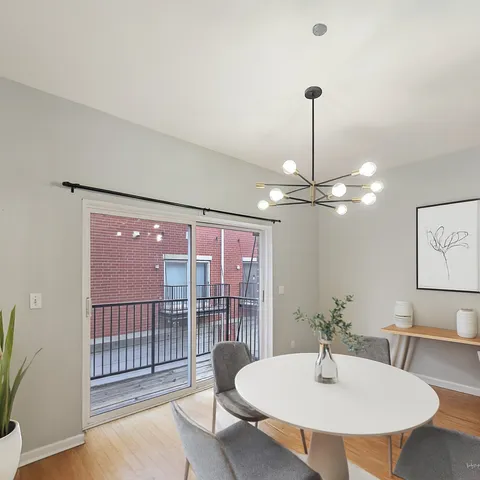 a view of a dining room with furniture wooden floor and chandelier