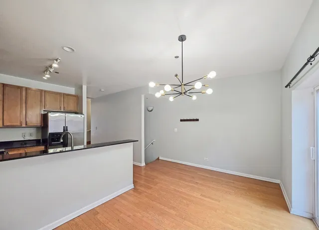 a view of a kitchen with a sink dishwasher a refrigerator and a stove