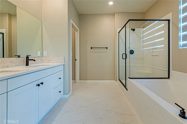 a spacious bathroom with a toilet sink and mirror