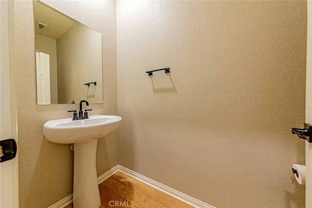 a bathroom with a granite countertop toilet and a sink