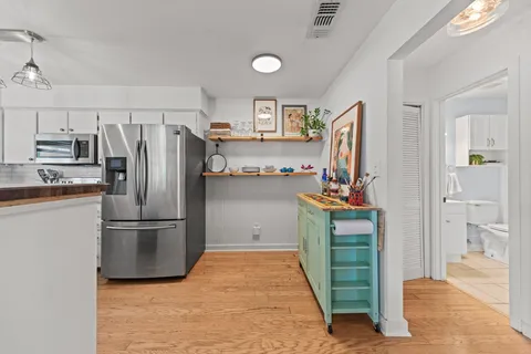 a kitchen with refrigerator and cabinets