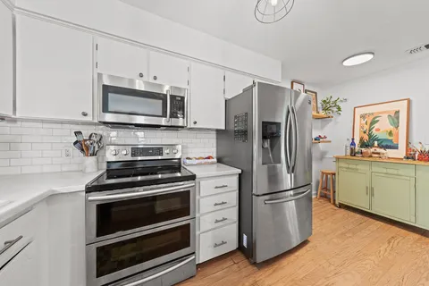 a kitchen with stainless steel appliances a refrigerator stove and microwave