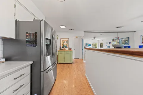 a kitchen with a refrigerator a sink and cabinets