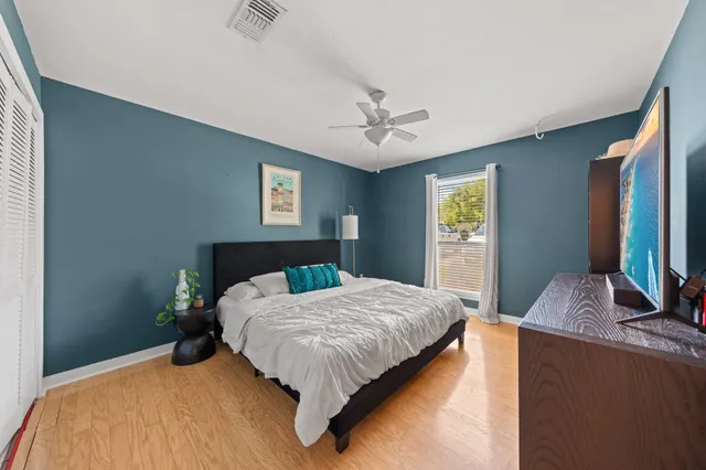 a bedroom with double bed and a flat tv screen on a dresser