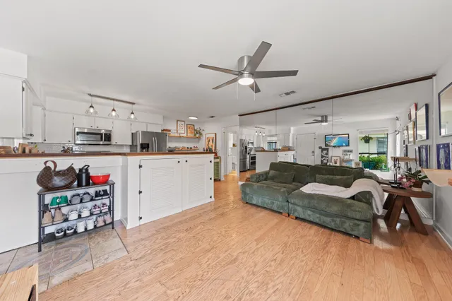 a living room with furniture and kitchen view