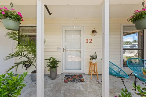 a front view of a house with a potted plant