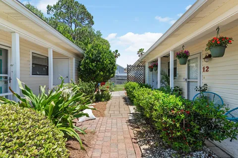 a view of a house with potted plants
