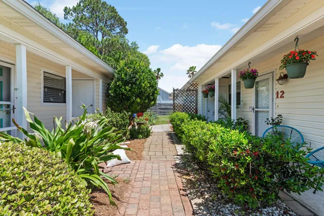 a view of a house with potted plants