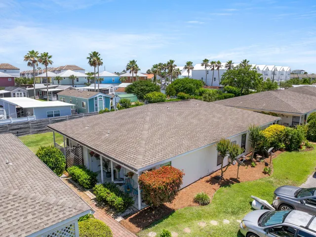 an aerial view of multiple house with a yard