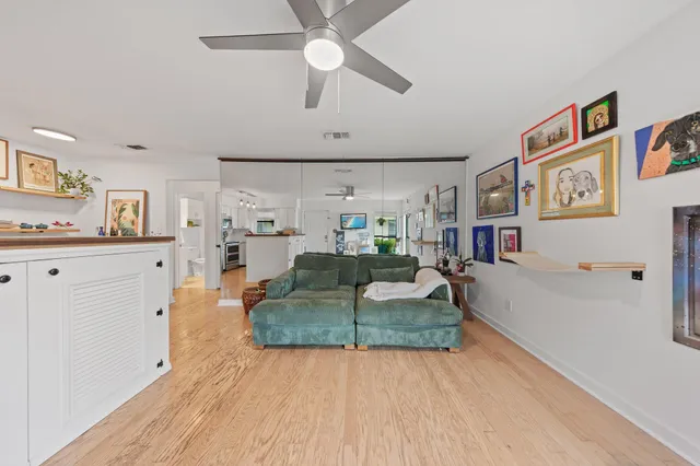 a living room with furniture and a wooden floor