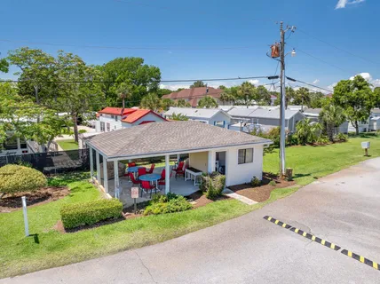 a aerial view of a house with a yard and potted plants