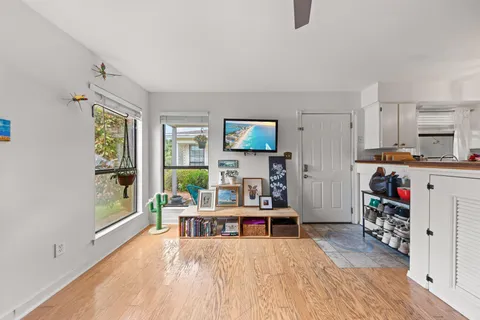 a living room with furniture and a wooden floor