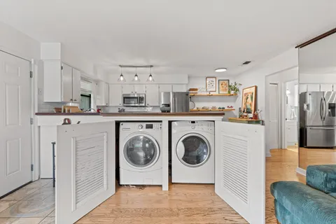 a utility room with sink dryer and washer