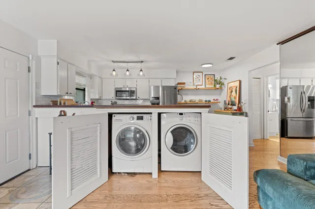 a utility room with sink dryer and washer