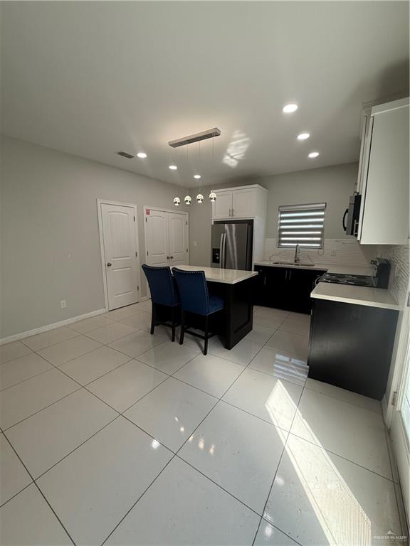 204 West Rutherford Avenue, Unit 4 Edinburg, TX 78541 - Photo 4 of 12 a large kitchen with stainless steel appliances kitchen island granite countertop a sink and cabinets
