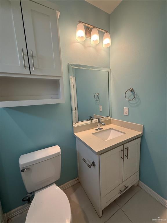 204 West Rutherford Avenue, Unit 4 Edinburg, TX 78541 - Photo 10 of 12 a bathroom with a toilet sink and mirror