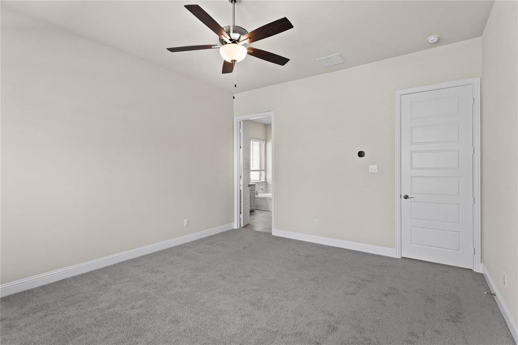 175 Mccartt Drive Lewisville, TX 75067 - Photo 7 of 22 Carpeted spare room with a ceiling fan, baseboards, and a smoke detector