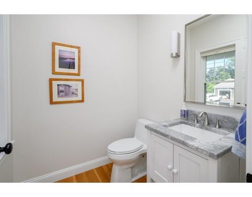 48 Marion Road Scituate, MA 02066 - Photo 16 of 33 a bathroom with a granite countertop toilet a sink and a mirror