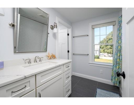 48 Marion Road Scituate, MA 02066 - Photo 19 of 33 a bathroom with a granite countertop sink a mirror and a shower