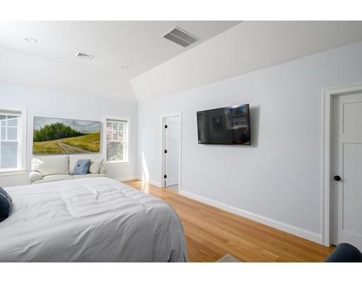 48 Marion Road Scituate, MA 02066 - Photo 22 of 33 a bedroom with a bed and a flat screen tv