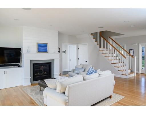 48 Marion Road Scituate, MA 02066 - Photo 5 of 33 a living room with furniture a fireplace and a flat screen tv