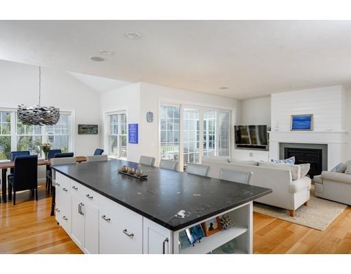 48 Marion Road Scituate, MA 02066 - Photo 7 of 33 a kitchen with stainless steel appliances granite countertop a sink dishwasher and a fireplace with wooden floor