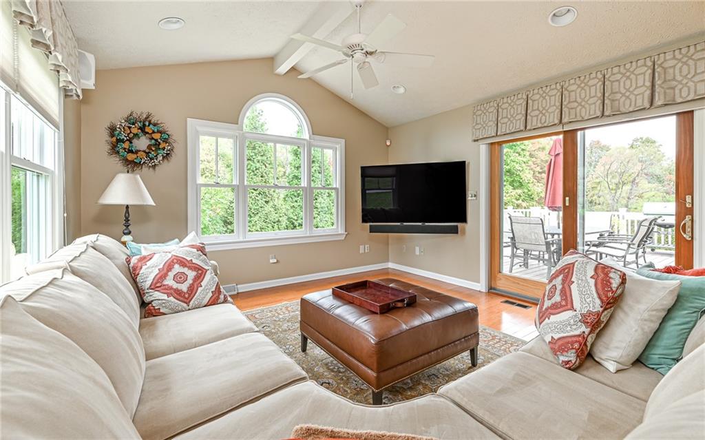 123 Weybridge Road Gibsonia, PA 15044 - Photo 12 of 25 a living room with furniture a flat screen tv and a floor to ceiling window