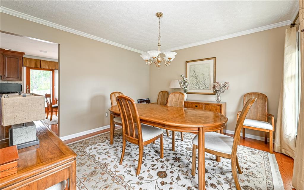 123 Weybridge Road Gibsonia, PA 15044 - Photo 3 of 25 a dining room with furniture a chandelier and wooden floor