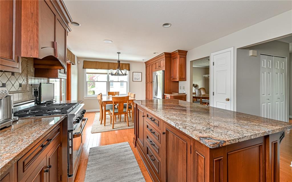 123 Weybridge Road Gibsonia, PA 15044 - Photo 5 of 25 a kitchen with granite countertop kitchen island stainless steel appliances a sink stove and cabinets
