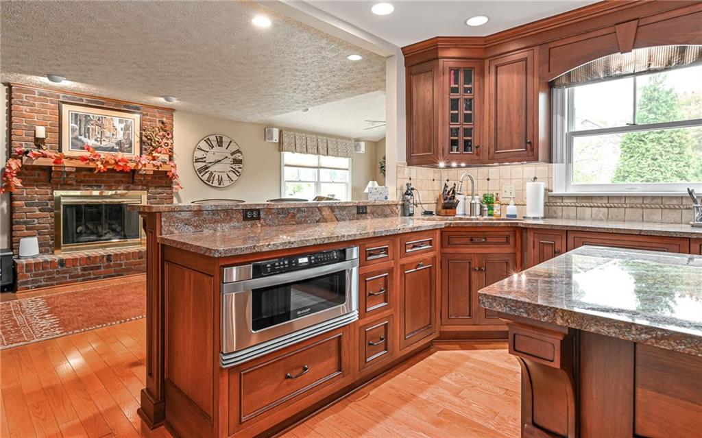 123 Weybridge Road Gibsonia, PA 15044 - Photo 8 of 25 a kitchen with stainless steel appliances granite countertop a stove a sink and a microwave