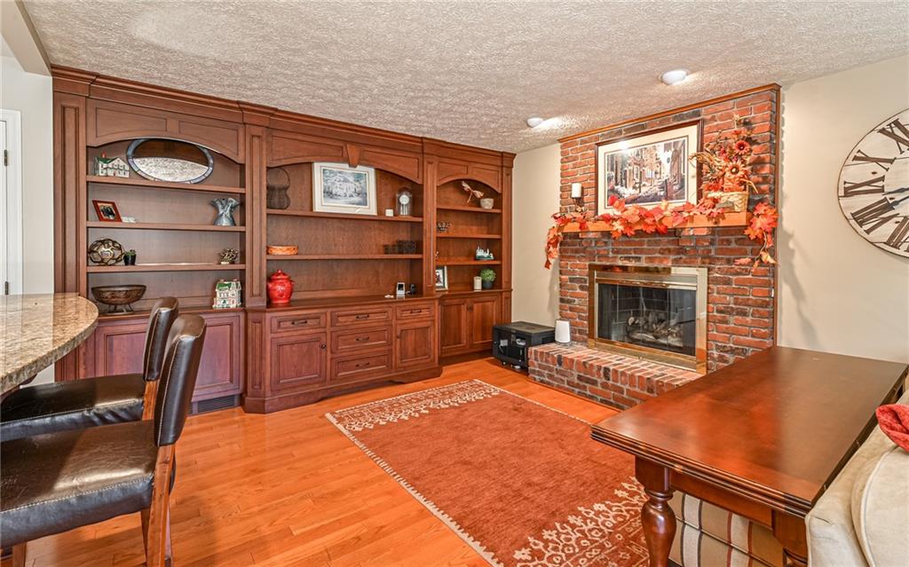 123 Weybridge Road Gibsonia, PA 15044 - Photo 10 of 25 a room with furniture and a fireplace