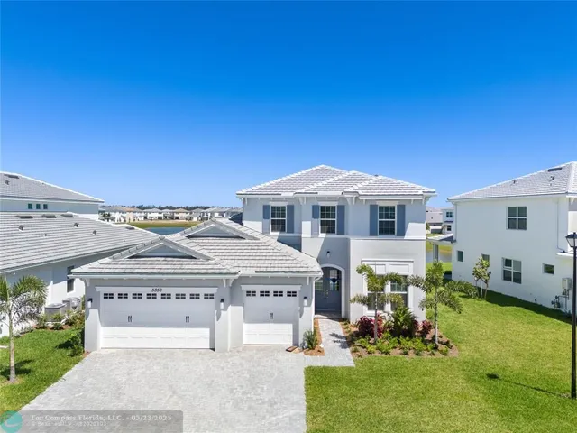 a aerial view of a house with a yard porch and furniture