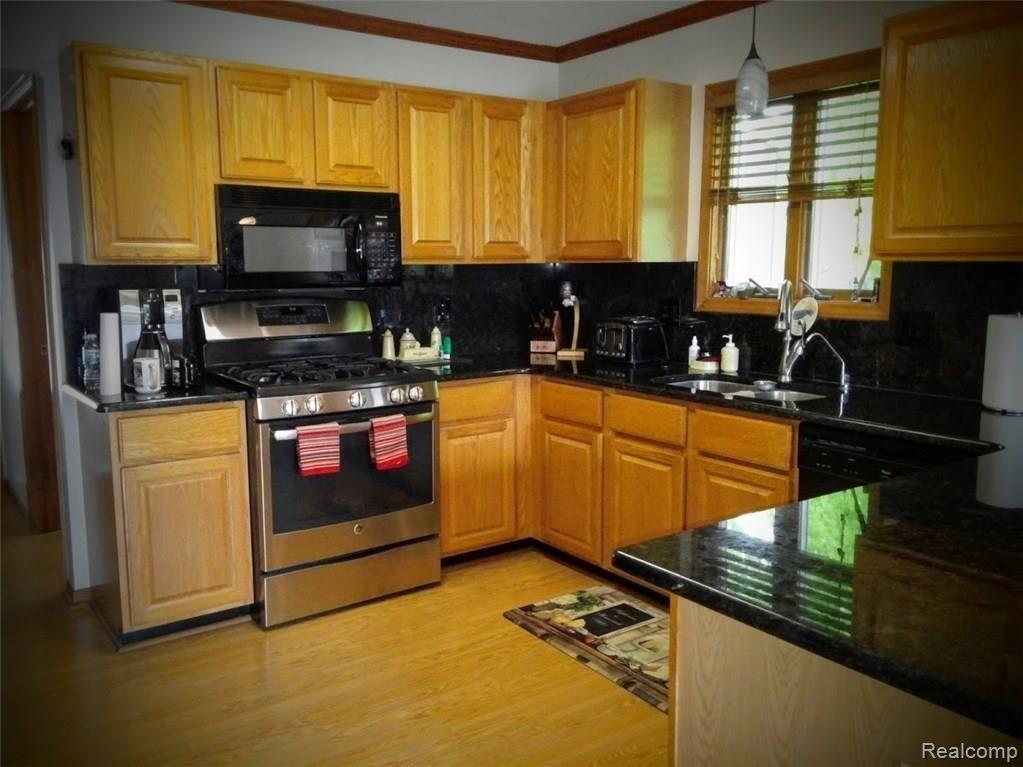 Kitchen with granite counters and stainless appliances.