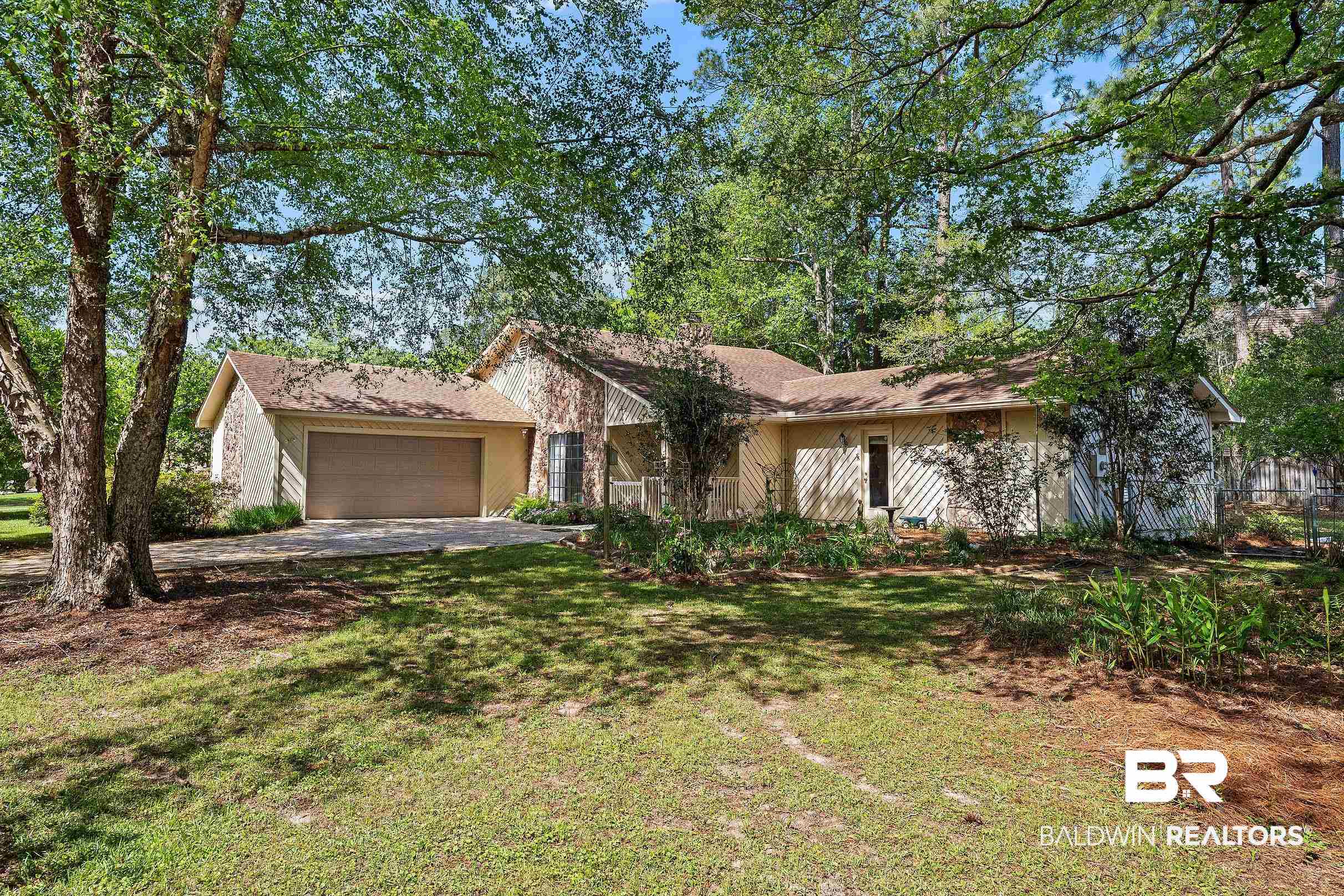 4026 Kingsrow Row Mobile, AL 36619 - Photo 48 of 51 View of front facade with a garage, a front lawn, and stone siding