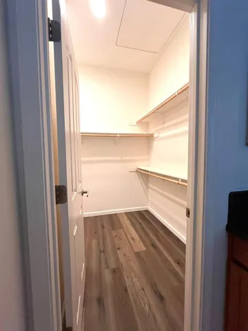 a bathroom with a toilet sink double vanity and mirror