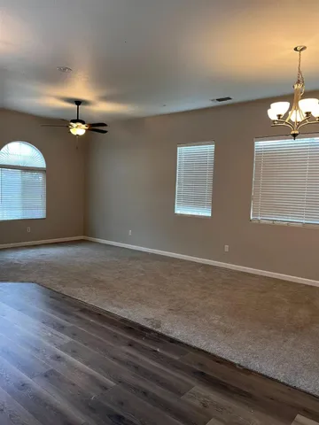 a view of a kitchen with kitchen island a sink stainless steel appliances and cabinets