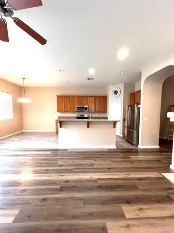 a kitchen with granite countertop cabinets and steel stove top oven