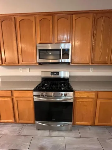 a kitchen with kitchen island a sink stainless steel appliances and cabinets