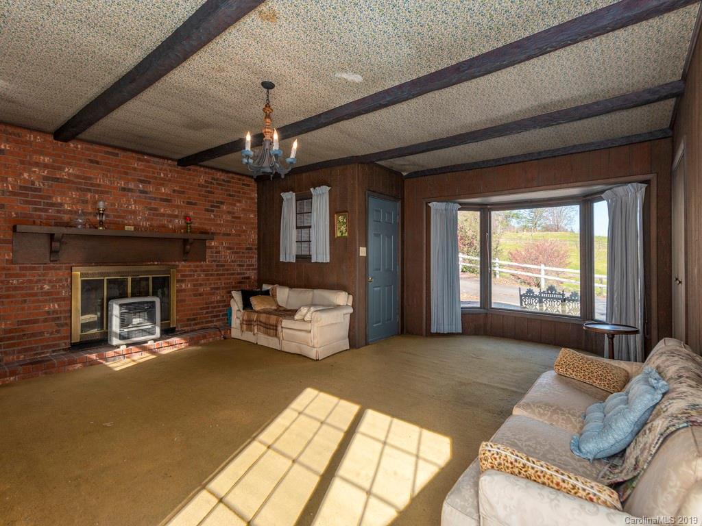 495 Howell Mill Road Waynesville, NC 28786 - Photo 14 of 24 a living room with furniture and a fireplace