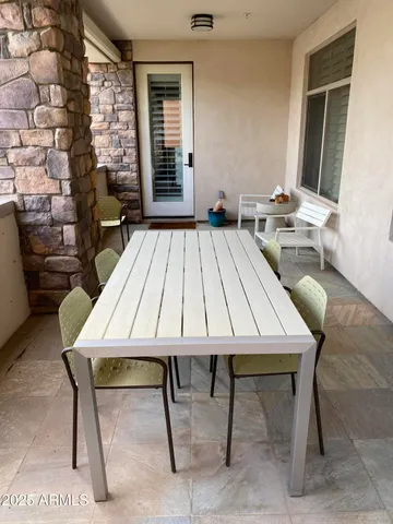 a table and chairs sitting in front of a house