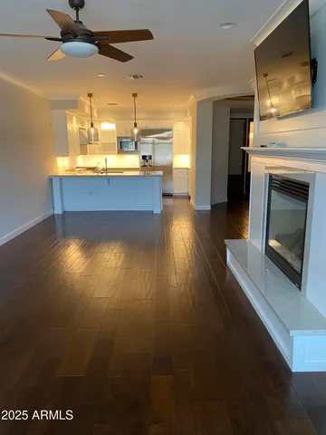 a kitchen with stainless steel appliances a fireplace a flat screen tv and island