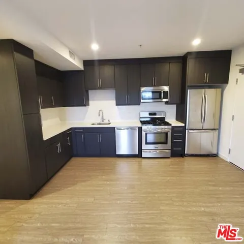 a kitchen with stainless steel appliances a refrigerator and a sink